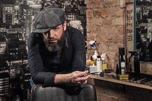 Portrait of stylish hairdresser man in his studio photo