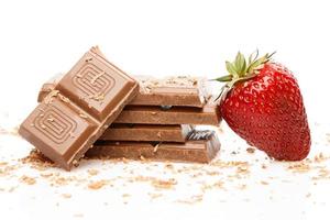 Strawberries and milk chocolate on white background photo