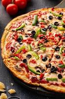 Vegetarian pizza with peppers, mushrooms and olives photo