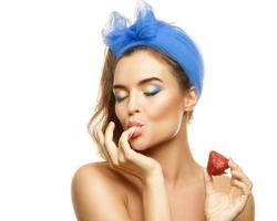 Beautiful woman with colorful make-up and strawberry photo