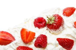 Whipped cream and sweet berries on white background photo