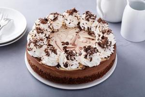 Chocolate cheesecake with whipped cream and chocolate shavings photo