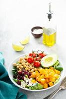 Vegan lunch bowl with chickpeas and roasted squash photo