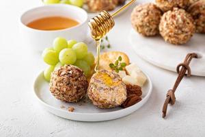 Cheese balls or truffles on a cheese board with crackers photo