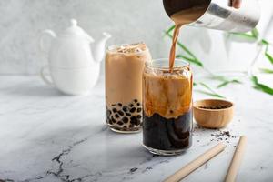 Boba milk tea in a tall glass with ice photo