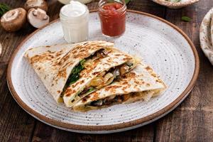 Mushroom and spinach quesadillas with sour cream and salsa photo