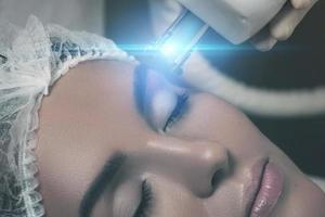 Beautiful woman in beauty salon during rejuvenation procedure photo