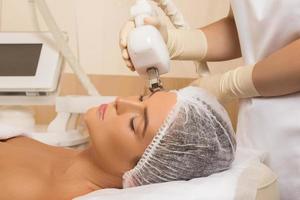 Beautiful woman in beauty salon during rejuvenation procedure photo