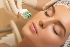 Beautiful woman in beauty salon during mesotherapy procedure. photo