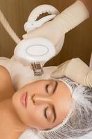 Beautiful woman in beauty salon during rejuvenation procedure photo