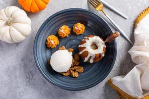 Pumpkin bundt cake soaked with rum served with ice cream photo