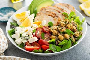 Healthy grilled chicken lunch bowl with chickpeas and feta photo