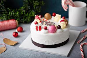 White chocolate Christmas celebration cake with holiday decorations photo