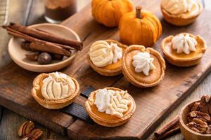 Mini pumpkin pies with wipped cream and cinnamon photo