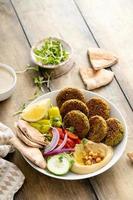 Baked falafel bowl with hummus and vegetables photo