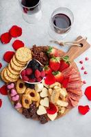Cheese plate for Valentines day with snacks and fruit photo