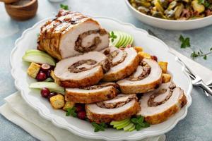 Roasted pork loin stuffed with apple and cranberry filling photo