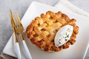 Peach pie topped with lattice and whipped cream photo