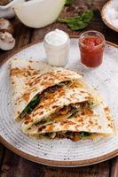 Mushroom and spinach quesadillas with sour cream and salsa photo