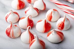 Peppermint meringues on a marble table, Christmas treat photo