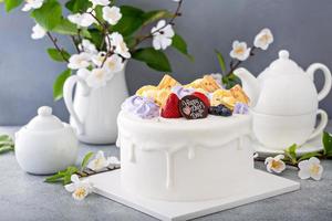 Vanilla cake for Mother's day with flowers and white chocolate glaze photo