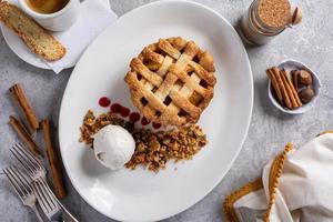 Traditional fall apple pie with lattice served with ice cream photo