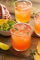 Spicy grapefruit margarita with chips and guacamole photo