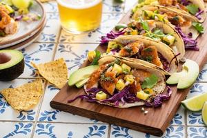 Fish tacos with mango salsa and red cabbage photo