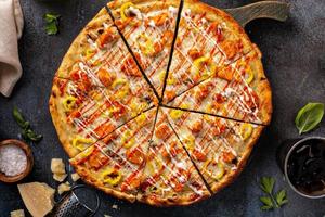 Chicken BBQ pizza with hot sauce sliced photo