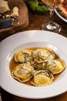 Freshly made brown butter cheese ravioli with sage photo