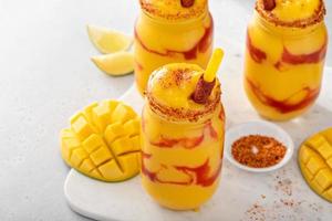 Mangonada mexican mango smoothie with chamoy sauce and lime seasoning photo