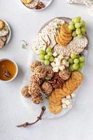 Cheese balls or truffles on a cheese board with crackers photo