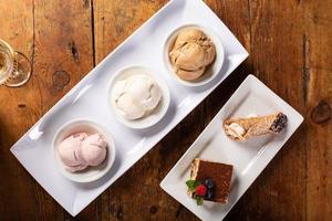 Italian desserts on the table, gelato, tiramisu and cannoli photo