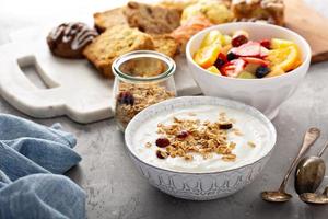 Breakfast table with granola, yogurt and fruit photo