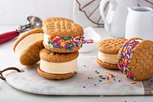 Ice cream and cookies sandwiches stacked on the table photo