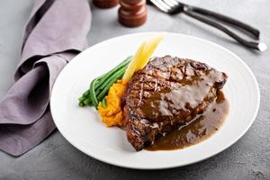 Grilled beef steak with gravy photo