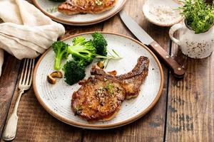 Grilled or pan fried pork chops on the bone photo