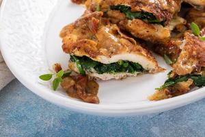 Spinach stuffed chicken on a serving platter photo