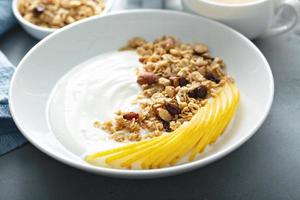 Plain yogurt with granola and pear photo