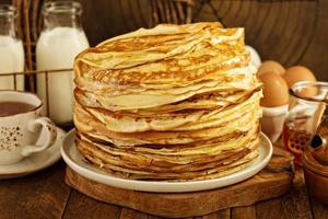 Stack of thin russian pancakes or crepes photo