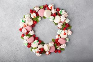 Christmas dessert wreath with macarons and meringues photo