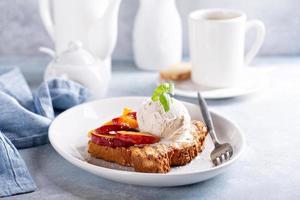 French toast with peaches and vanilla ice cream photo