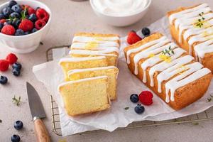 Classic vanilla pound cake with powdered sugar glaze sliced on parchment photo