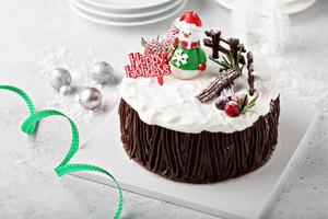 Chocolate Christmas celebration cake with holiday decorations photo