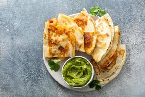 Shrimp and cheese quesadillas served with guacamole photo