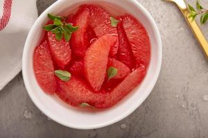 Fresh grapefruit slices in a bowl photo