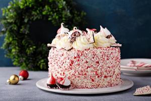 Peppermint bark and chocolate cake for Christmas on a festive background photo