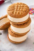 Ice cream and cookies sandwiches stacked on the table photo