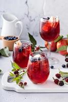 Fall berry and apple sangria in a glass with ice photo