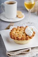 Peach pie topped with lattice and whipped cream photo